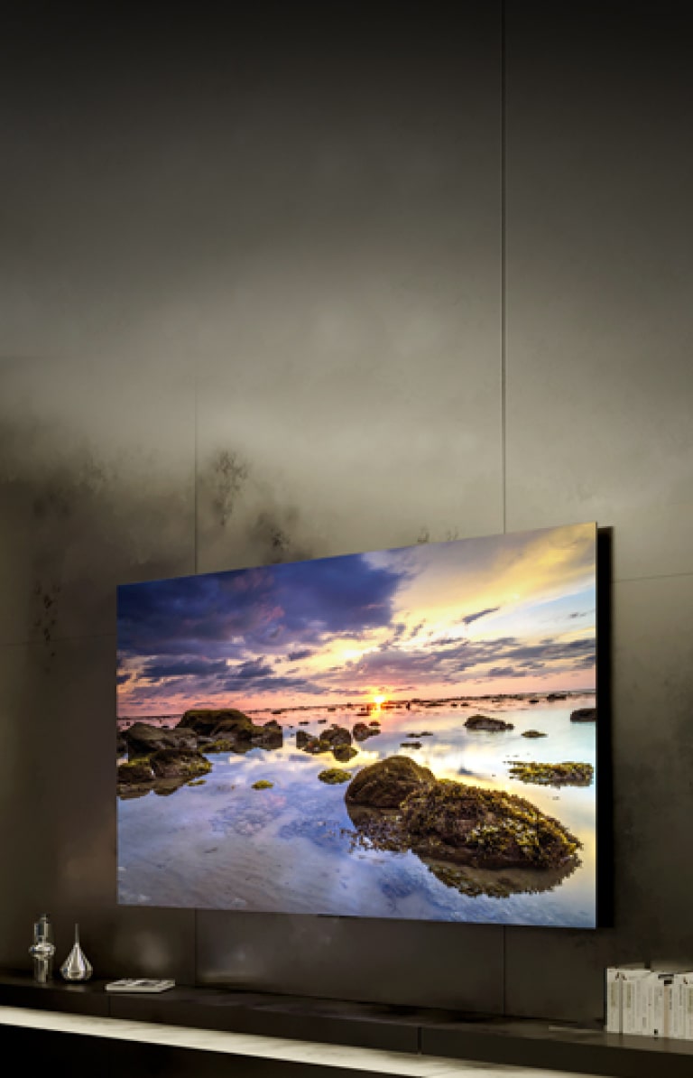 Photo of a large OLED TV hanging on a dark wall